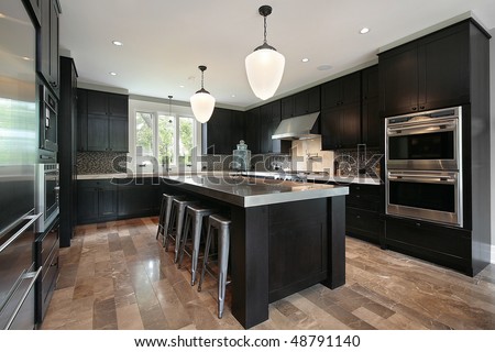 Kitchen in luxury home with dark wood cabinetry