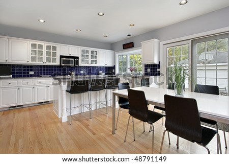Kitchen in suburban home with blue tile back splash