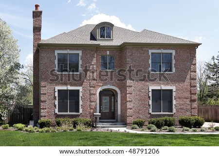 Brick home in suburbs with arched entry