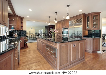 Kitchen in luxury home with black marble counter tops