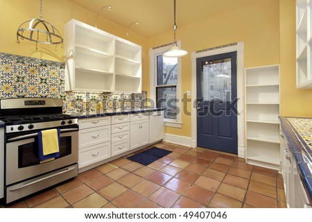 terra cotta tile kitchen on Kitchen In Suburban Home With Terra Cotta Floor Tile Stock Photo