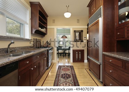 Kitchen in luxury home with wood paneled refrigerator