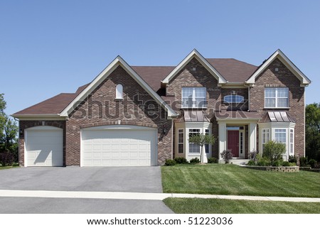 Brick home in suburbs with covered entry