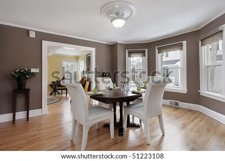 Dining room in suburban home with wall of windows