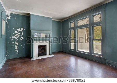Living room with fireplace in old abandoned home