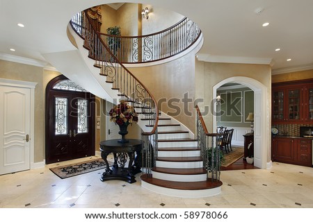 Foyer in luxury home with circular staircase