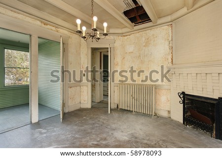 Dining room with peeling paint in old abandoned home