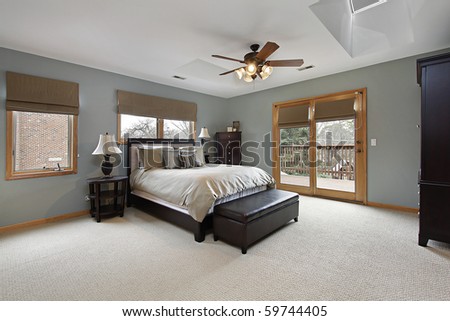 Master bedroom with doors leading to deck