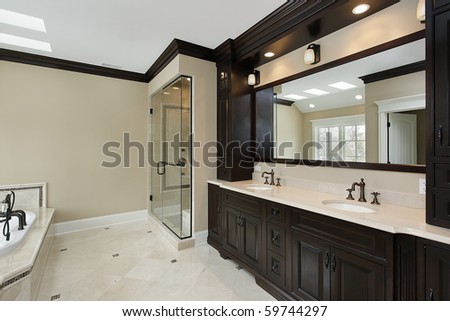 Master bath in new construction home with dark cabinetry