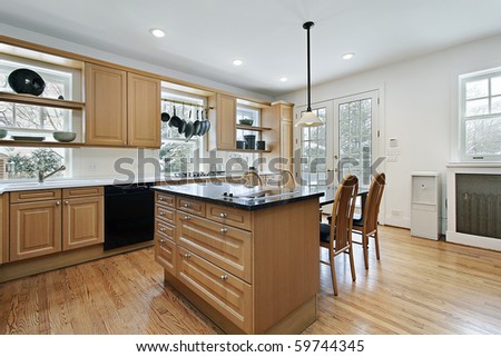 Kitchen in remodeled home with oak wood cabinetry