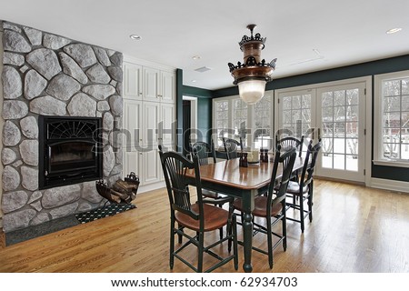 Breakfast room in luxury home with stone fireplace