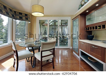 Eating area in luxury home with wood cabinetry