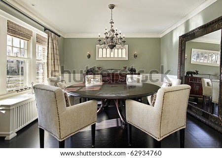 Dining room in luxury home with olive walls
