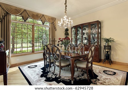 Dining room in suburban home with gold draperies