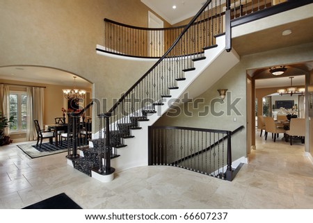 Home Stairs Design on Foyer In Luxury Home With Curved Staircase Stock Photo 66607237