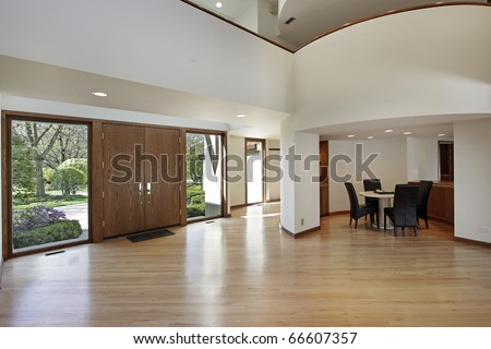 Foyer in luxury home with rounded second floor landing