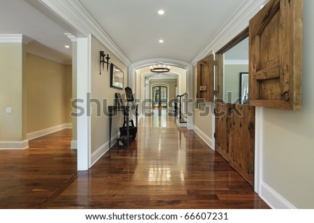Long foyer with wooden barn doors into living room stock photo ...