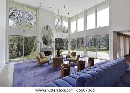 Family room in luxury home with two story windows