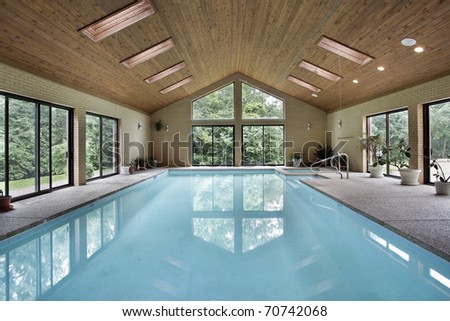Indoor pool in luxury home with skylights