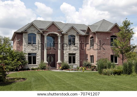 Brick home with stone front and white columns