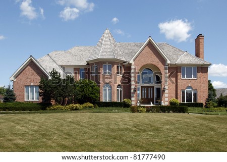 Luxury home with arched entry and turret