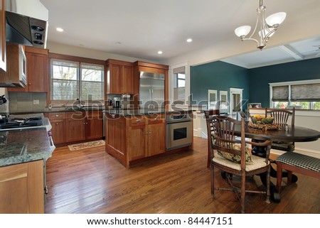 Upscale kitchen with island and family room view