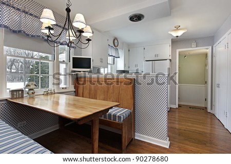 Kitchen in suburban home with eating area and bench
