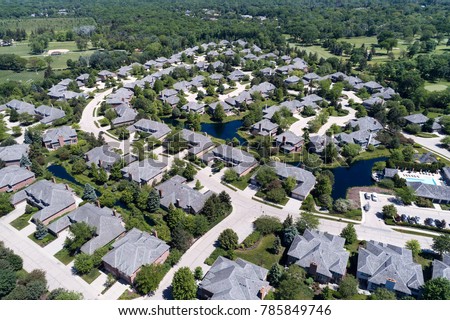 Aerial view of a neighborhood housing complex with ponds in the Chicago suburban city of Northbrook, IL in summer. USA.