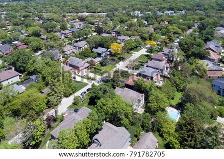 Aerial view of a neighborhood with mature trees in a Chicago suburban neighborhood in summer. Deefield, IL. USA