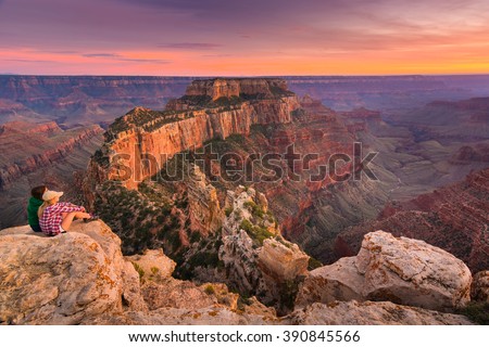 A Group of People Was Sitting Near The Edge Watching Sunset at Grand Canyon National Park North Rim, USA