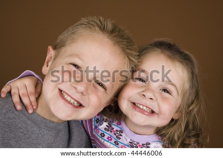 Brother and sister sharing a happy hug.