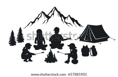 Family sit around campfire silhouette scene with mountains, tent and pine trees. People camping outdoor