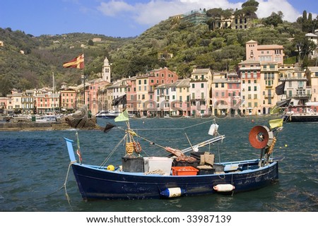 Scenic view of the Italian Riviera fishing village of Portofino with a fishing boat in the foreground
