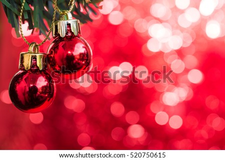 Christmas ball ornament decoration on fir tree over red circle bokeh blurred background with copy space for text, greeting card happy new year 2017