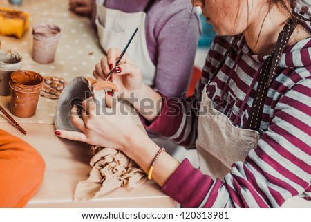 children's hands sculpts clay crafts pottery school