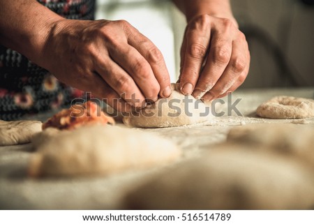 homemade cakes of the dough in the women\'s hands. The process of making pie dough by hand