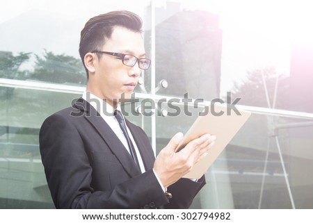 Business man using a variety of mobile devices, mobile phones, smart watches, tablet, computer