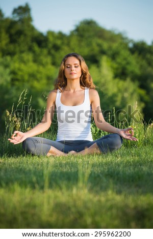 Yogi girl meditating with nature. Girl in lotus pose thinking about beautiful spirit.
