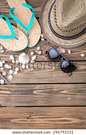 Picture of necessary summer objects necessary for vacation. Flip-flops, straw hat and sunglasses to feel comfortable during your trip.