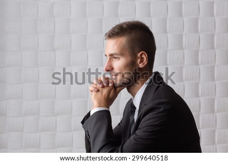 Close-up profile of smiling businessman isolated on white. Happy bearded man with short hair clasped his hands.