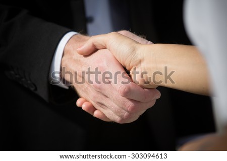 Business handshake and business people. Business handshake for closing the deal after singing the lucrative contract between companies.