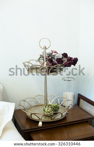 Close-up picture of flower-stand in modern interior of home or hotel. There are faded flowers corresponding to romantic or love atmosphere.