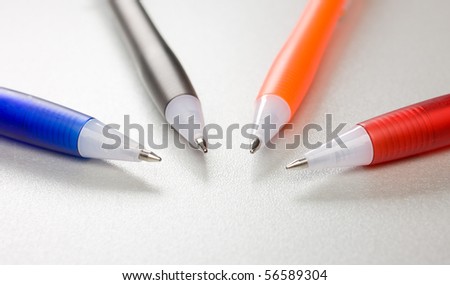 Set of colored pens on grey table