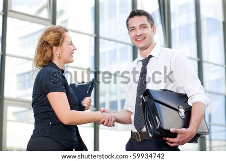 Happy office workers greet each other outdoor