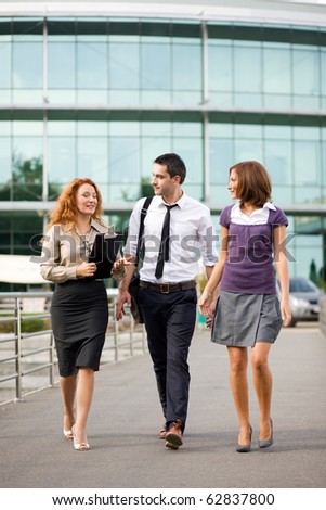 Group of office workers walk outdoor