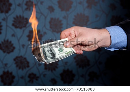Fire burn one hundred dollars in  hand