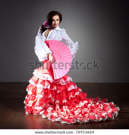 Flamenco dancer in beautiful dress on dark background