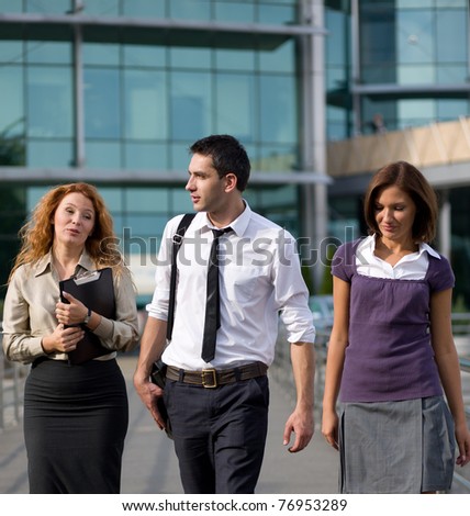 Group of  workers walk across office building
