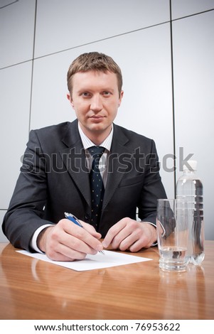 Real office worker posing for camera in board room