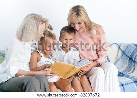 Mother and grand mother read book with children